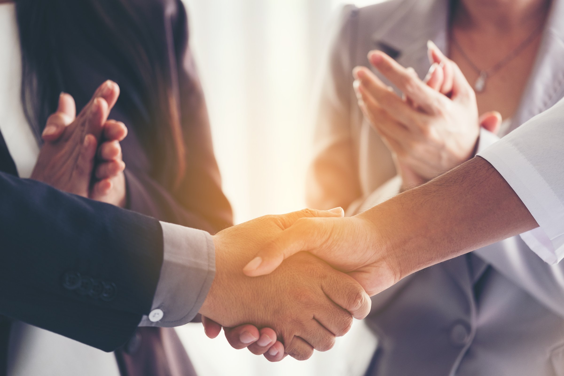 Businessmen making handshake in the city - business etiquette, c